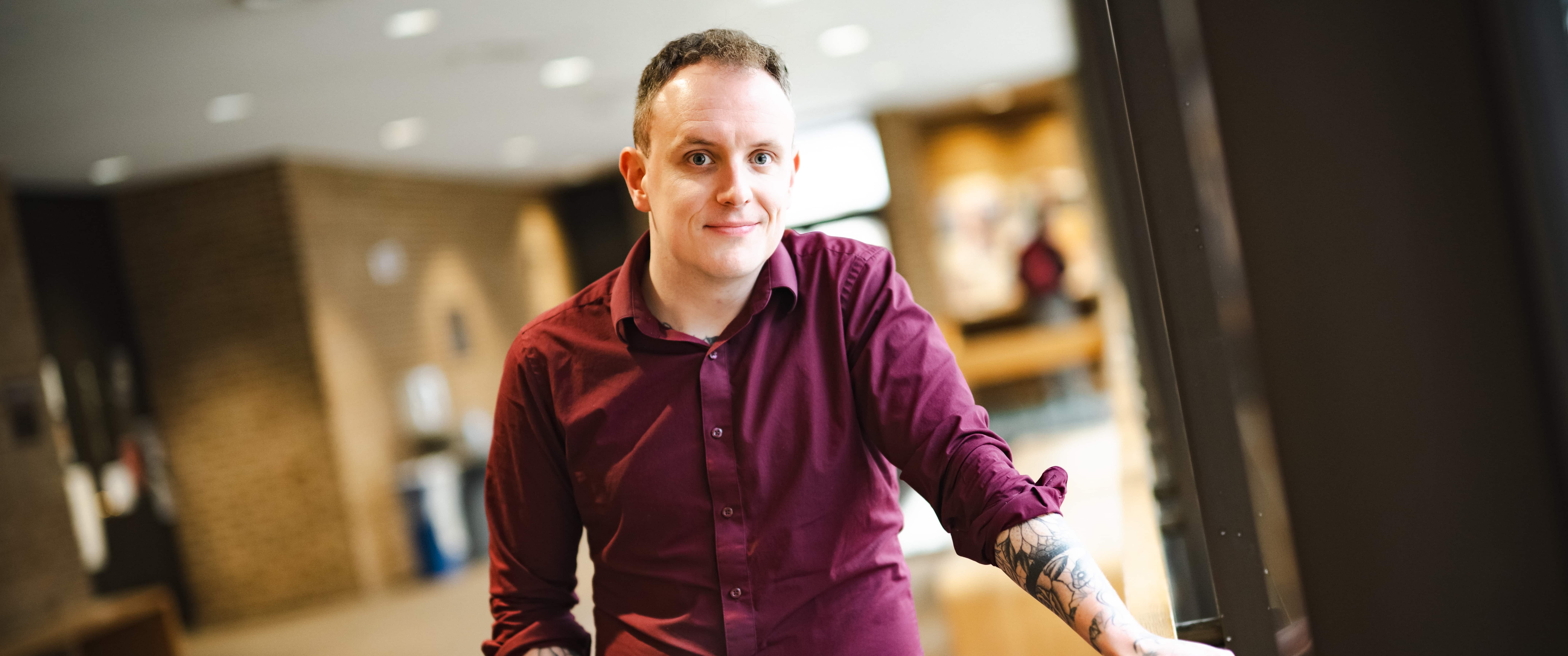 Daniel Laverty stands in a hallway