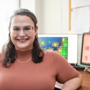 Lisa Fredin, assistant professor of chemistry, smiling in her office.