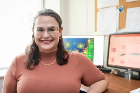 Lisa Fredin, assistant professor of chemistry, smiling in her office.