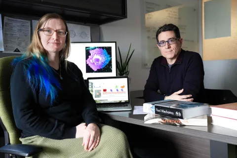 Aurelia Honerkamp-Smith and Damien Thévenin, professor of chemistry, sitting together in an office.