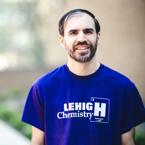 Robert Hamburger standing in front of brick building wearing a blue Lehigh Chemistry t-shirt.