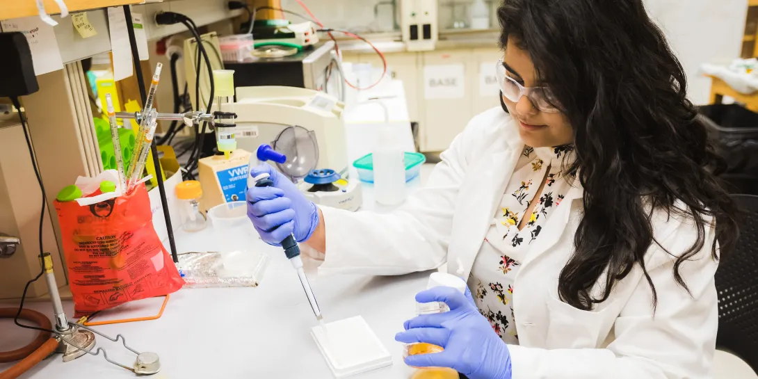 Ph.D. student Aarshi Singh in a chemistry lab.